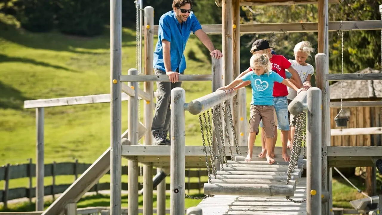 Kinder spielen auf einem Klettergerüst im Freien.