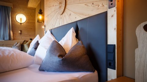 Gemütliches Schlafzimmer mit Kissen und Holzdetails