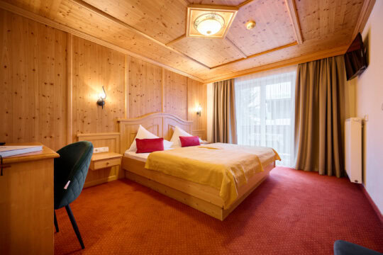 Gemütliches Hotelzimmer mit Holzdekor und Fenster