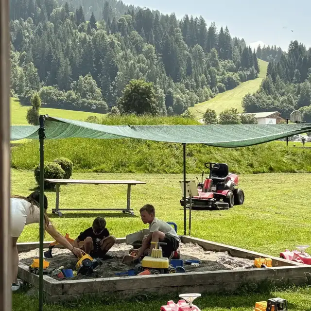 Kinder spielen im Sandkasten im Freien.